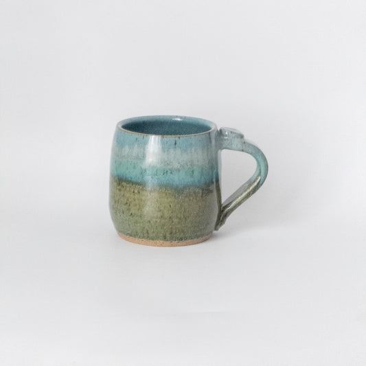 Ceramic mug with a two-tone design on a white background