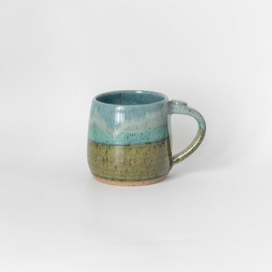 Ceramic mug with two-tone glaze on a white background
